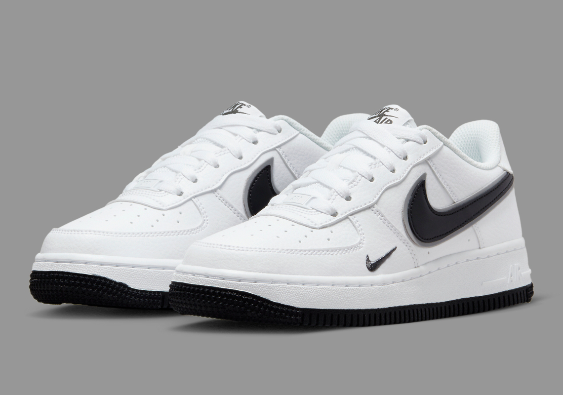 The Kid's Nike Air Force 1 Low Appears In A Clean "White/Black" Look With Layered Swooshes