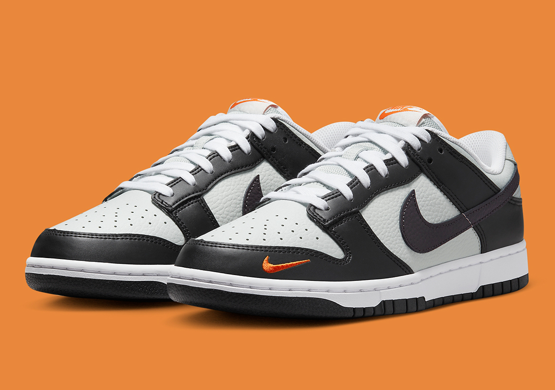 Nike Brightens Up This Black And Grey Dunk Low With Miniature Orange Swooshes